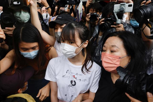 불법집회 참가 혐의 등으로 수감됐던 홍콩 민주화 운동가 아그네스 차우(가운데)가 12일 수감 7개월여 만에 석방돼 교도소를 나오는 길을 취재진이 둘러싸고 있다. 홍콩=로이터 연합뉴스
