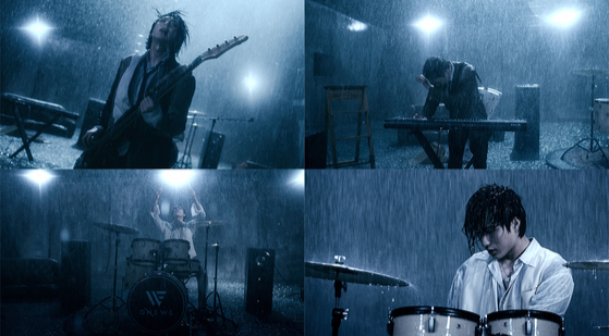 Captured images from boy band Onewe's new track ″Rain To Be″ featuring members of the band singing in the pouring rain. [RBW]