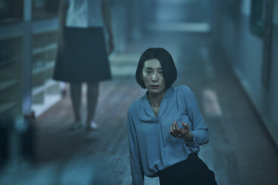 Kim Seo-hyung portrays Eun-hee, the vice principal of a school in her hometown in Gwangju, still haunted by her memories with her best friend in “Whispering Corridors 6: The Humming.” [KTH]