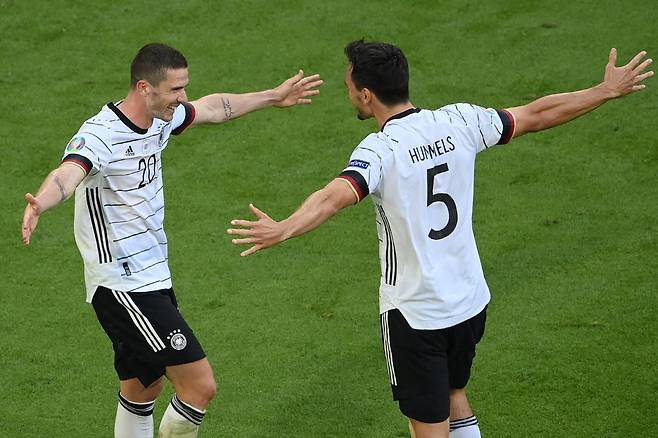 Germany's defender Robin Gosens (L) celebrates scoring their fourth goal with Germany's defender Mats Hummels (R) during the UEFA EURO 2020 Group F football match between Portugal and Germany at Allianz Arena in Munich on June 19, 2021. (Photo by Matthias Hangst / POOL / AFP)