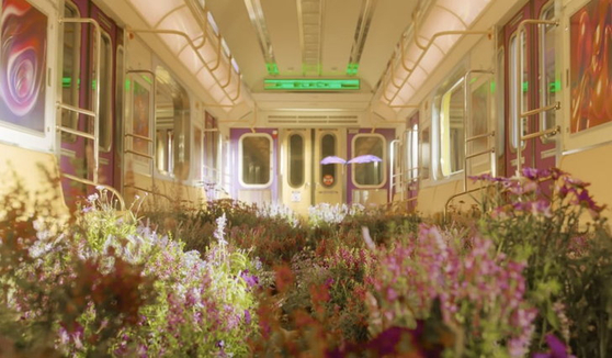 NCT U’s music video for “Make A Wish (Birthday Song)” (2020) ends showing a butterfly fluttering through a subway car overgrown with flowers, a scene which reappears in the “Black Mamba” music video released by aespa a month later. [SCREEN CAPTURE]