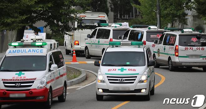 국내 신종 코로나바이러스 감염증(코로나19) 신규 확진자가 2223명을 기록한 11일 오후 경기도 수원시 영통구 경기대학교 생활치료센터가 확진자를 이송하는 구급차들로 붐비고 있다. 지난해 1월 20일 국내 코로나19 확진자가 처음 발생한 이후 569일만에 처음으로 2000명대를 넘어섰다. 2021.8.11/뉴스1 © News1 김영운 기자