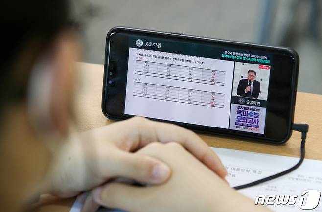 (서울=뉴스1) 이승배 기자 = 24일 서울 양천구 목동종로학원에서 열린  2022수시 최종지원전략 비대면 설명회에서 학생들이 휴대폰을 통해 영상을 보고있다. 2021.07.24/뉴스1