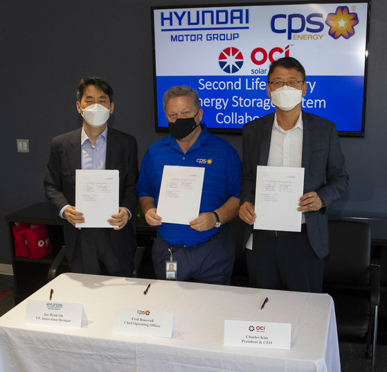 From left, Oh Jae-hyuk, vice president of energy business development group at Hyundai Motor Group, Fred Bonewell, chief operating officer at CPS Energy and Charles Kim, CEO of OCI Solar Power pose for a photo Sept. 14 after signing a memorandum of understanding at OCI Solar Power headquarters at San Antonio in Texas.