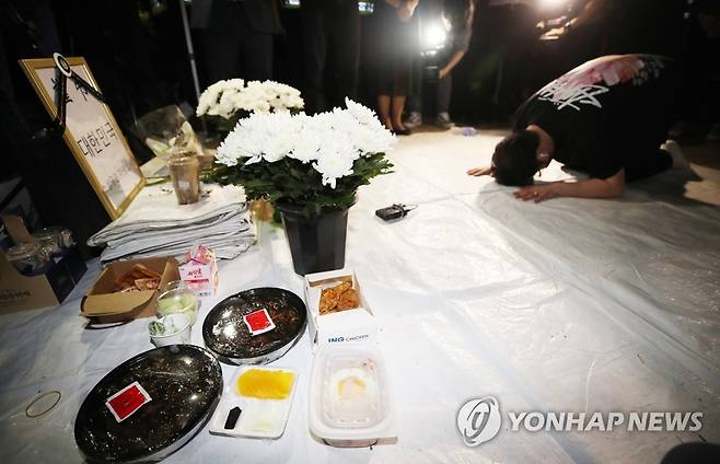 추모하는 자영업자들 (서울=연합뉴스) 박동주 기자 = 전국자영업비상대책위원회 소속회원들이 16일 오후 여의도 국회의사당역 3번 출구 앞에 최근 생활고에 시달리다 세상을 떠난 자영업자들을 추모하고 정부에 영업제한조치 철폐를 촉구하는 분향소를 설치한 뒤 예를 갖추고 있다. 분향소에는 국화와 음식 등이 놓여 있다. 2021.9.16 pdj6635@yna.co.kr