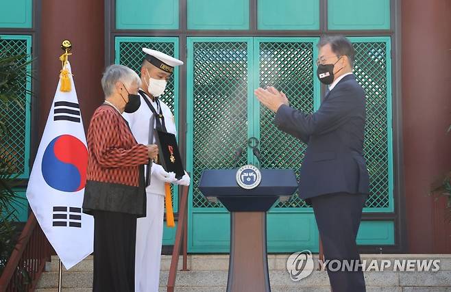 애국장 추서하는 문 대통령 (호놀룰루=연합뉴스) 최재구 기자 = 문재인 대통령이 22일(현지시각) 미국 하와이대 한국학 연구소에서 열린 독립유공자 훈장 추서식에서 독립유공자 김노디 지사 후손에게 애국장을 수여한 뒤 박수치고 있다. 2021.9.23 jjaeck9@yna.co.kr