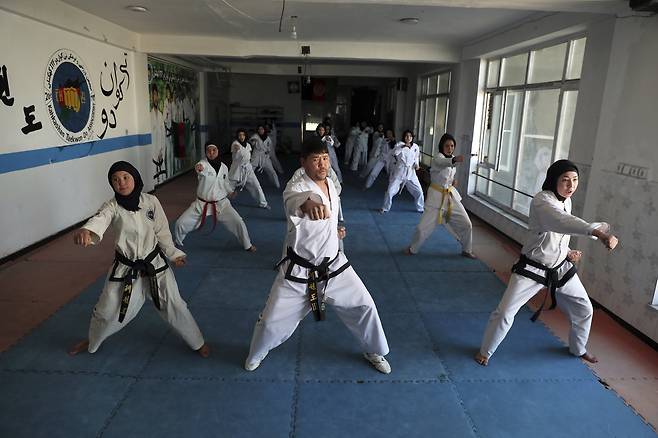 지난 3월 아프간 소녀들이 사범님과 몸통지르기 훈련을 하고 있다. AP=연합뉴스