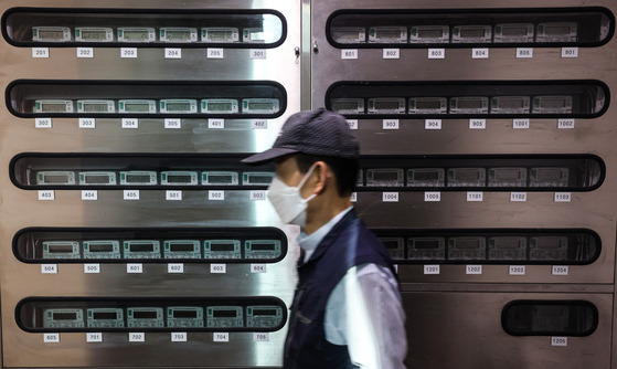 A man walks by electric meters at an apartment complex in Seoul on Sept. 23. The government announced electricity price rise for the first time in eight years. [YONHAP]