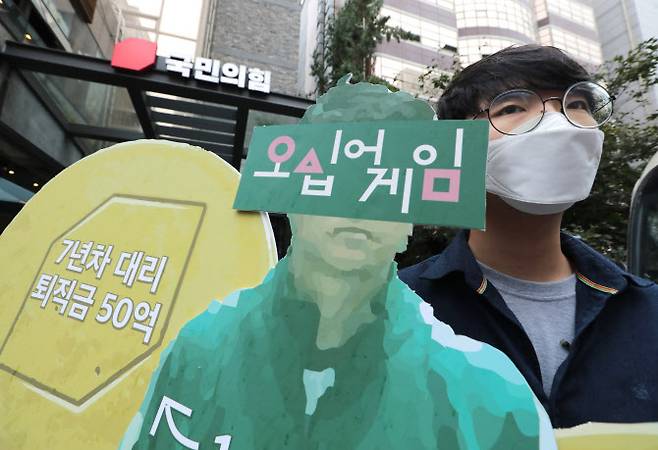 대장동 개발 사업을 둘러싼 정치권의 공방이 계속된 29일 서울 영등포구 국민의힘 중앙당사 앞에서 2022 대선대응 청년행동 관계자가 곽상도 의원 아들의 50억 퇴직금을 비판하는 피켓을 들고 있다 (사진=뉴스1)