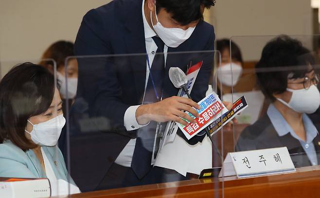 1일 서울 서초구 대법원에서 열린 국회 법제사법위원회의 대법원(법원행정처), 사법연수원 등에 대한 국정감사에서 법사위 직원이 국민의힘에서 부착한 '대장동 특검' 게시물을 여야 합의에 따라 제거하고 있다. 연합뉴스