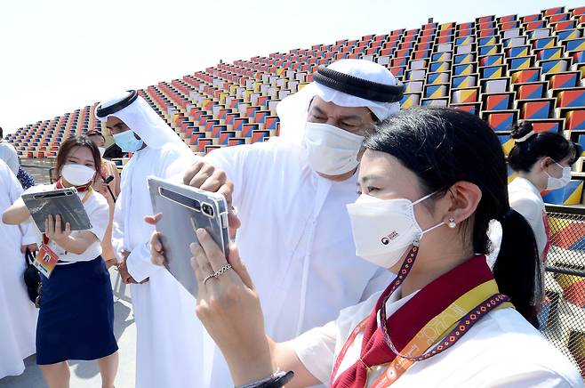 A visitor holds up a mobile device to launch the augmented reality program at the Korea Pavilion at the Expo 2020 Dubai on Friday. (Courtesy of Kotra)