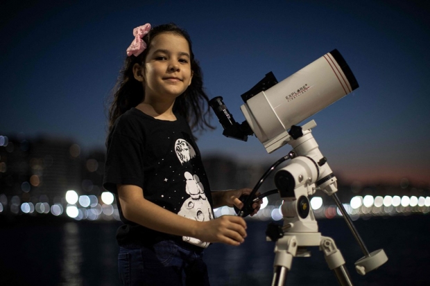 최연소 천문학자 니콜레 올리베이라(8)가 9월 21일 자신의 천체망원경과 함께 사진을 찍었다. 사진=AFP 연합뉴스