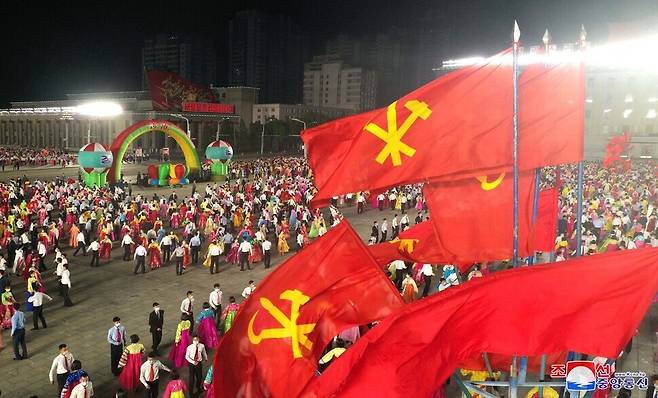 North Koreans can be seen celebrating the 76th anniversary of the founding of the WPK in Kim Il-sung Square on Sunday evening. (KCNA/Yonhap News)