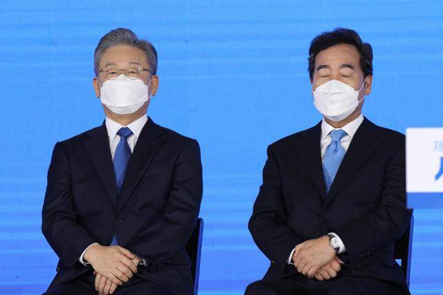 더불어민주당 대선후보에 선출된 이재명(왼쪽) 경기지사가 10일 서울 올림픽공원에서 열린 서울 경선에 참석해 이낙연 전 대표와 함께 경선 결과를 듣고 있다. 연합뉴스