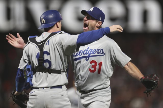 Los Angeles Dodgers catcher Will Smith, left, celebrates with pitcher Max Scherzer (31) after defeating the San Francisco Giants in Game 5 of a baseball National League Division Series Thursday, Oct. 14, 2021, in San Francisco. (AP Photo/Jed Jacobsohn)