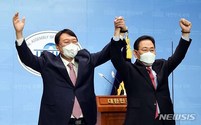 [서울=뉴시스] 최진석 기자 = 윤석열(왼쪽) 국민의힘 대선 경선 후보와 선거대책위원장으로 합류한 주호영 의원이 17일 오전 서울 여의도 국회 소통관에서 공동 기자회견을 가진 후 손을 들어 인사하고 있다. (공동취재사진) 2021.10.17. photo@newsis.com