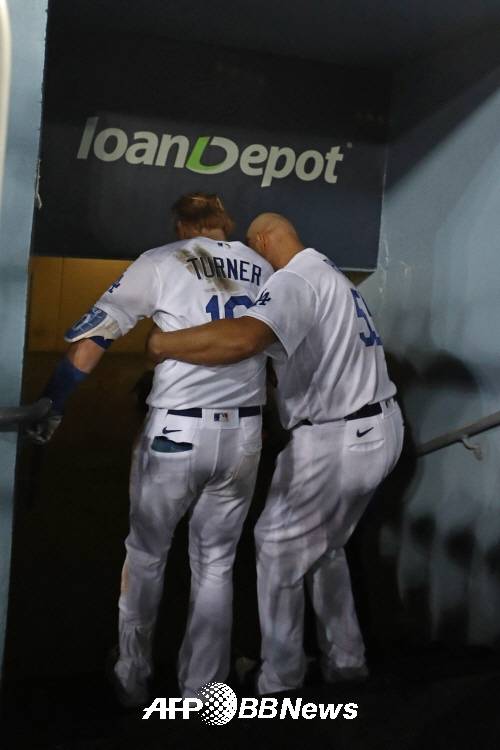 동료 알버트 푸홀스의 부축으로 경기장을 떠나는 터너(왼쪽). ⓒAFPBBNews = News1