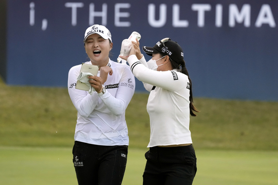 Ko Jin-young, left, reacts as she celebrates with other players after winning the BMW Ladies Championship at LPGA International Busan in Busan on Sunday/ [AP/YONHAP]