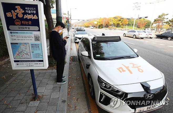 자율주행차 호출서비스 시연 (시흥=연합뉴스) 홍기원 기자 = 2일 오후 경기도 시흥시 정왕동 오이도역 앞에서 관계자들이 수요 응답형(호출형) 자율주행 모빌리티 서비스 시연을 하고 있다.
    자율주행 모빌리티 서비스 시범사업은 서울대 산학협력단 컨소시엄이 사업자로 선정돼 작년 5월부터 추진해온 것이다.
    컨소시엄은 아이오닉 6대, e카운티 1대 등 총 7대의 자율차를 제작했으며 전용 애플리케이션(앱)인 '마중'의 예약시스템에 기반한 수요응답형 서비스를 개발했다.
    이를 활용해 시흥 배곧신도시 일대에서 심야 대중교통 이용이 불편한 거주민을 위한 안전귀가 셔틀 서비스 등을 제공해왔다. 2021.11.2 xanadu@yna.co.kr