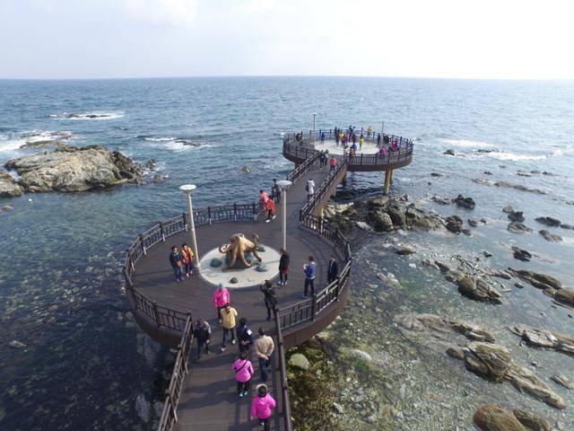 해돋이 명소인 경북 포항시 남구 호미곶면을 찾은 관광객들이 해맞이 광장 앞에 설치된 전망덱(deck)에서 주변 경관을 감상하고 있다. 덱 가운데에 호미곶 앞바다에 서식하는 돌문어를 본떠 만든 조형물이 설치돼 있다. 포항시 제공