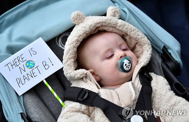 기후 시위에 나선 아기 [글래스고[영국] 로이터=연합뉴스]  5일(현지시간) COP26이 개최되는 영국 글래스고에서 열린 기후변화 시위에서 아기가 '플래닛B는 없다'는 문구 옆에서 자고 있다.photo@yna.co.kr 2021.11.6