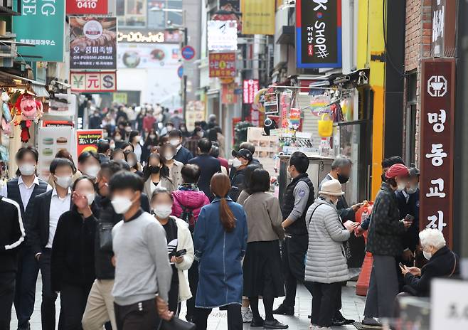 The shopping district of Myeongdong in Seoul bustles with people during lunchtime last Monday, the first day of the introduction of the eased social distancing "With COVID-19" scheme. (Yonhap)