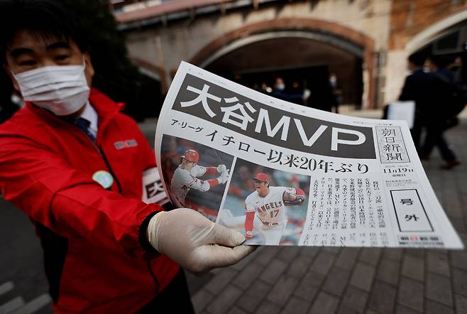 오타니 쇼헤이가 19일 MLB 아메리칸리그 MVP를 수상하자 일본 열도가 들썩였다. 일본 내 모든 매체들이 이 소식을 속보로 전했고, 이를 다룬 호외가 거리에 뿌려지기도 했다. 사진은 한 일본 시민이 오타니의 MVP 등극 소식이 담긴 호외를 든 모습./로이터 연합뉴스