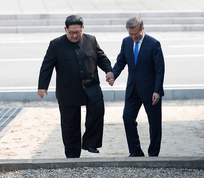 문재인 대통령과 김정은 북한 국무위원장이 지난 2018년 남북정상회담 당시 판문점에서 만나 인사를 나눈후 군사분계선을 넘었다가 함께 걸어 내려오고 있다. /한국공동사진기자단