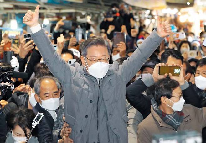 더불어민주당 이재명(가운데) 대선 후보가 5일 전북 정읍 샘고을시장에서 시민들에게 두 손을 들어 인사하고 있다. 이 후보는 “이제 선택해야 한다”며 “더 유능한 정부, 더 국민의 아픈 곳을 살피고 국민의 더 나은 삶을 꾸려갈 이재명 정부가 필요하다”고 했다. /연합뉴스