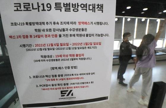 지난 8일 오후 세종시의 한 보컬·댄스학원에서 입시생이 연습하고 있는 가운데 신종 코로나바이러스 감염증(코로나19) 방역패스 안내문이 보이고 있다. 연합뉴스