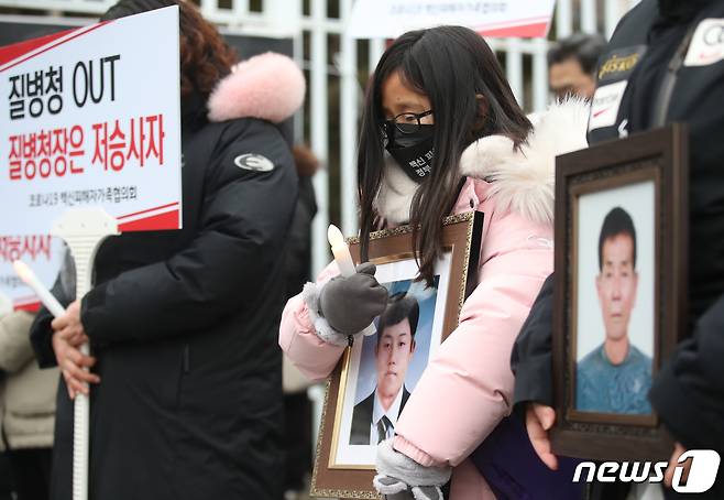 8일 오후 서울 종로구 정부서울청사 앞에서 코로나19백신피해자가족협의회(코백회) 주최로 열린 코로나19 백신피해 인가성 인정 촉구 집회에서 유가족들이 묵념을 하고 있다. 코백회는 지난해 말부터 매주 토요일마다 코로나19 백신 부작용을 호소하고 정부의 방역패스를 비판하는 집회를 해 왔다. 코백회 관계자는 "가족을 잃고, 백신 부작용을 경험한 사람들이 어떻게 방역패스를 찬성할 수 있겠냐＂며 ＂회원 수가 200명에서 500명으로 크게 늘었다＂고 밝혔다. 2022.1.8/뉴스1 © News1 ,송원영 기자