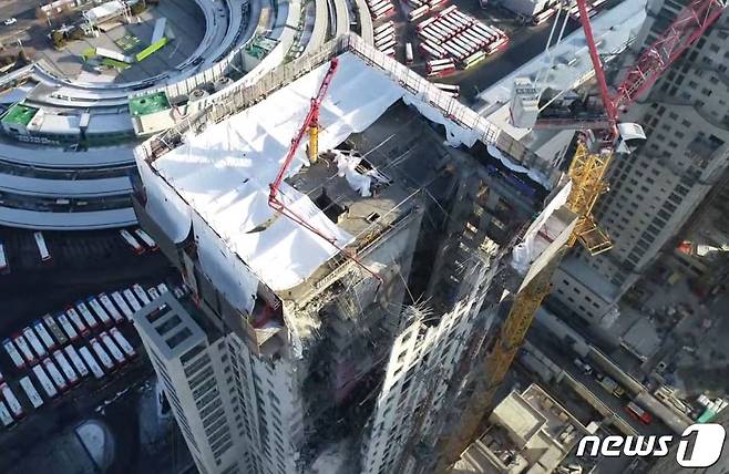 현대산업개발 아파트 신축 공사 붕괴 사고가 발생한 광주 화정동 화정아이파크 상공 촬영. 39층 높이의 아파트 3분의 1 가량의 바닥과 구조물, 외벽이 처참하게 무너져 있다. 외벽에 설치된 타워크레인도 추가 붕괴 우려가 있다.(광주시 제공 영상 캡처)2022.1.13/뉴스1 © News1