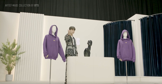 Jungkook introduces Jimin's purple hoodie as if he's a home shopping host. The YouTube video of it was uploaded on Monday. [SCREEN CAPTURE]