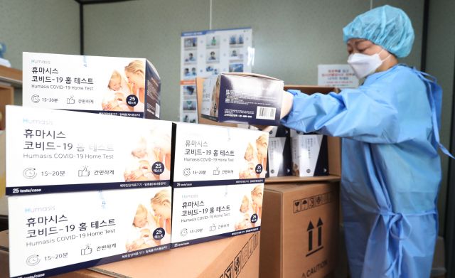 코로나19 의료진이 28일 서울역에 마련된 임시 선별검사소에서 신속항원검사를 위한 자가진단키트를 정리하고 있다. 연합뉴스