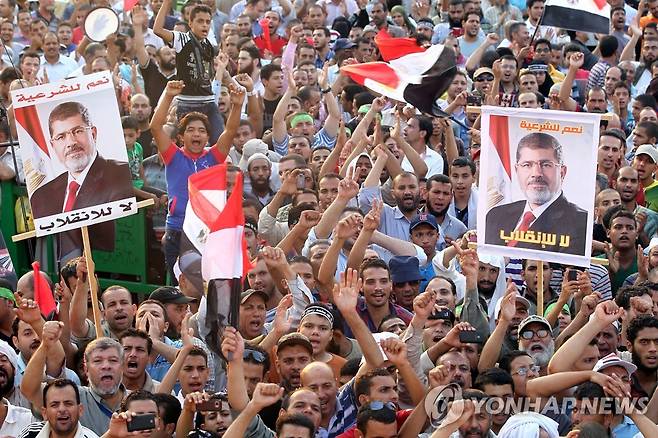2013년 8월 카이로에서 열린 무함마드 무르시 대통령 축출 반대 집회에 참석한 무슬림형제단 지지자들. [EPA 연합뉴스 자료사진. 재판매 및 DB 금지]