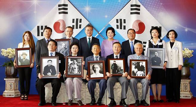 문재인 대통령과 김정숙 여사가 2018년 8월 14일 청와대 영빈관에서 열린 독립유공자 및 유족 초청 오찬 후 참석자들과 기념촬영하고 있다./조선일보DB