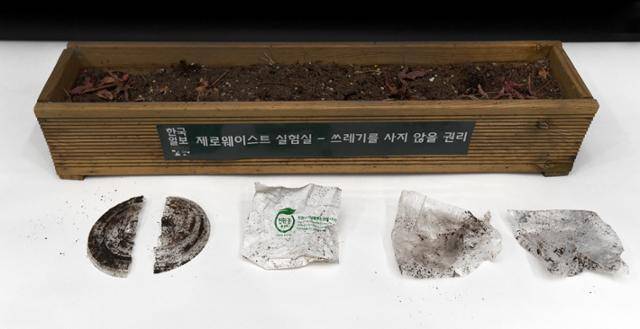 한국일보 기후변화팀이 생분해성 플라스틱을 흙에 묻어봤다. 6개월이 지났지만 분해의 흔적은 찾아보기 어렵다. 왼쪽부터 ①블루보틀의 PLA 생분해 컵 뚜껑, ②스타벅스의 PET 뚜껑, ③씨유(CU) PLA 생분해 비닐, ④산화생분해 비닐, ⑤LDPE 재질의 비닐. 서재훈 기자