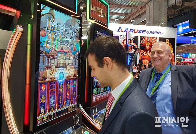 ▲지난 2019년 5월 마카오 베네시안에서 열린 G2E ASIA 행사의 강원랜드 부스를 방문한 카지노 업계 관계자들이 사베리 머신을 살펴보고 있다. ⓒ프레시안