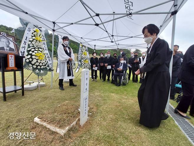 한승헌 변호사의 묘비에 아내 김송자씨가 마지막 헌화를 하기 위해 나서고 있다. 한 변호사의 묘에는 정식으로 묘비가 제작되기 전까지 임시로 나무 묘비를 세워뒀다.