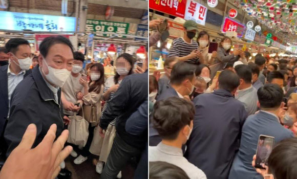 윤석열 대통령이 취임 후 첫 주말인 14일 서울 종로구 광장시장을 방문하고 있다. 대통령실은 윤 대통령이 부인 김건희 여사와 함께 광장시장을 찾아 빈대떡과 떡볶이 등을 포장 구매했다고 밝혔다. 2022.5.14 연합뉴스