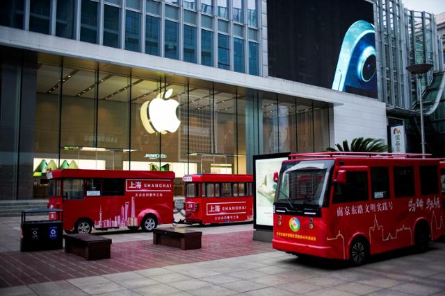 18일 중국 상하이에 있는 애플 스토어 앞을 관광버스가 지나가고 있다. 상하이는 22일 기준 56일째 봉쇄 중이다. 상하이=로이터 연합뉴스