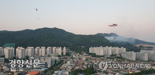 22일 오후 경남 김해 야산에서 산불이 발생해 산불진화헬기가 불을 끄고 있다.│연합뉴스