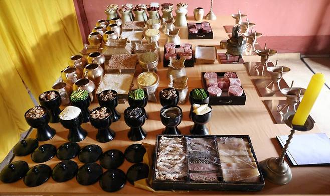 Some 45 dishes of cooked and raw food are served on elevated dishes with drinks at the annual royal ancestral rite with court music at Jongmyo Shrine in Seoul. Photo © Hyungwon Kang