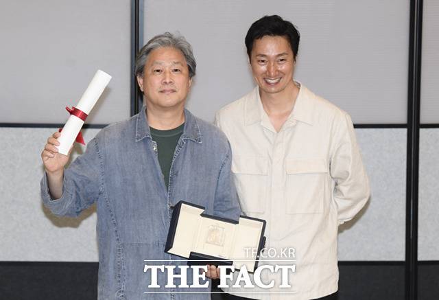 제 75회 칸영화제 시상식에서 영화 '헤어질 결심'으로 감독상을 수상한 박찬욱 감독(왼쪽)과 주연을 맡은 배우 박해일이 30일 오후 인천국제공항으로 귀국해 기념촬영을 하고 있다.