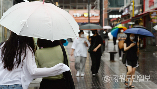 ▲ 강원 춘천 명동에서 시민들이 우산을 쓰고 길을 걷고 있다. [강원도민일보 자료사진]