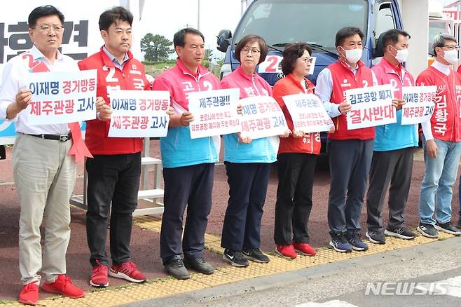 [제주=뉴시스] 양영전 기자 = 국민의힘 제주도당이 지난 28일 오전 제주시 마리나호텔 사거리에서 인천 계양을 보궐선거에 출마한 더불어민주당 이재명 후보의 김포공항 이전 및 국내선 기능 폐지 관련 발언을 규탄하는 기자회견을 연 가운데 제주지역 국민의힘 소속 지방선거 후보자들이 회견에 참석해 팻말을 들고 있다. 2022.05.28. 0jeoni@newsis.com