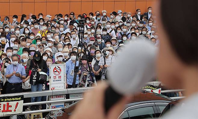 7월 10일 실시되는 일본 참의원 선거 유세 첫날인 22일 도쿄에서 유권자들이 선거 유세 연설을 듣고 있다. 도쿄=AFP연합뉴스