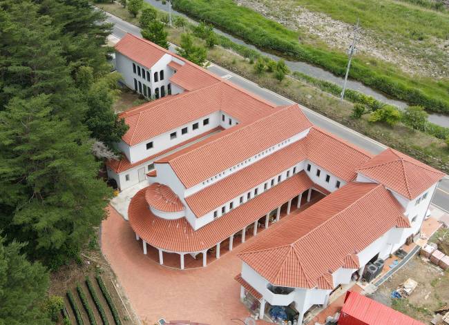 삼척 방주교회는 붉은 기와지붕을 한 건물이 바깥 회랑으로 이어지며 주변 자연풍경과 어우러진다. 장재선 선임기자·삼척방주교회 드론 촬영