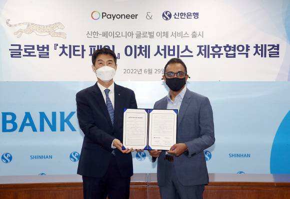 29일 서울 중구 신한은행 본점에서 열린 업무협약식 에서 신한은행 기업그룹 최익성 부행장(좌측)과 페이오니아 나게시 드바타 부사장이 기념촬영을 하고 있다. [사진=신한은행]