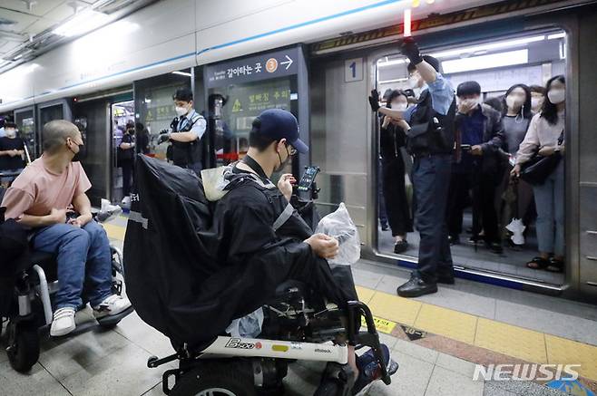 [서울=뉴시스] 최동준 기자 = 전국장애인차별철폐연대가 30일 서울 지하철 4호선 충무로역에서 장애인 권리 예산 보장 등을 요구하며 지하철 승하차 시위를 하고 있다. 2022.06.30. photocdj@newsis.com